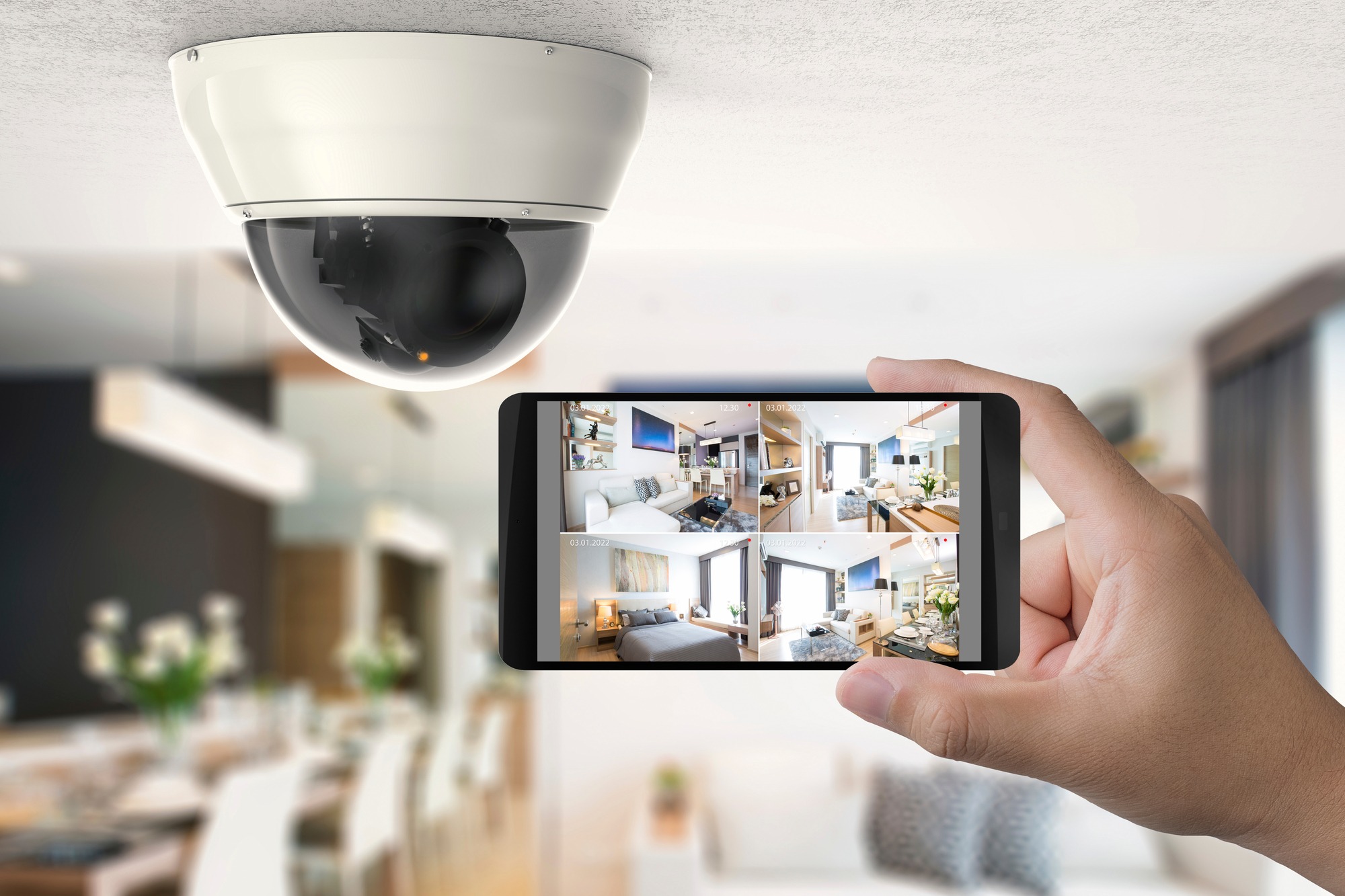 Hand holding mobile connect with security camera